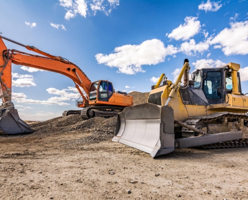 Side view of two excavators at a construction site